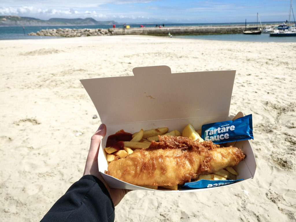 Having fish and chips at the beach in England should be on your travel bucket list.