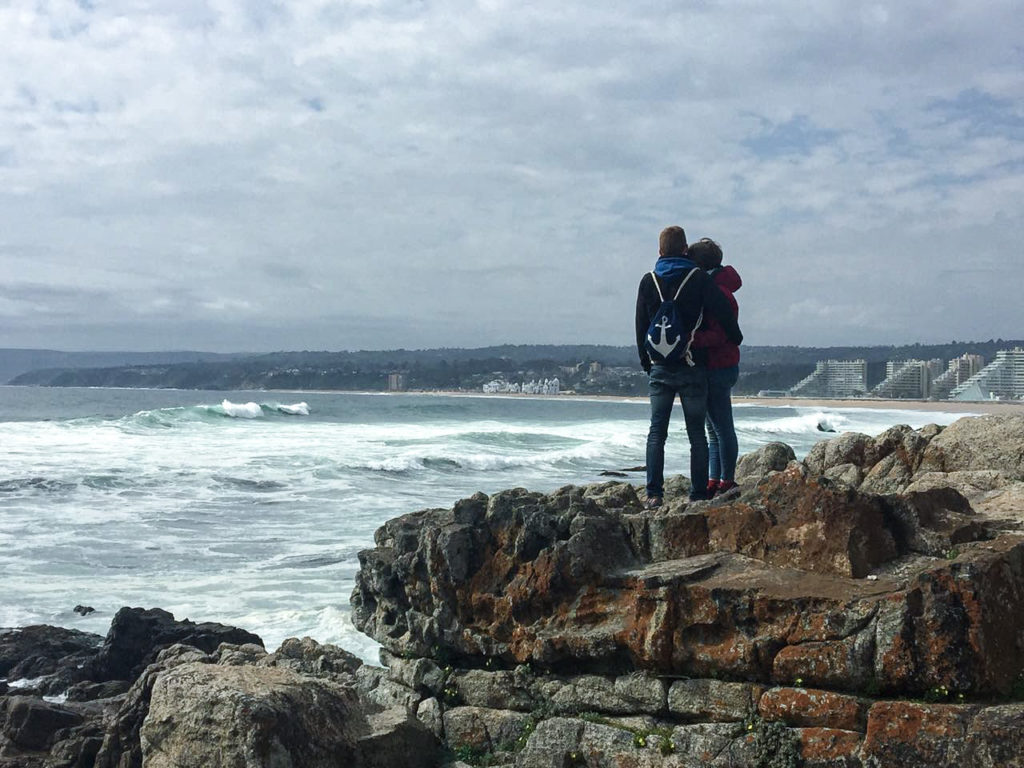 Standing at the ocean on our travels through the world makes us very happy.