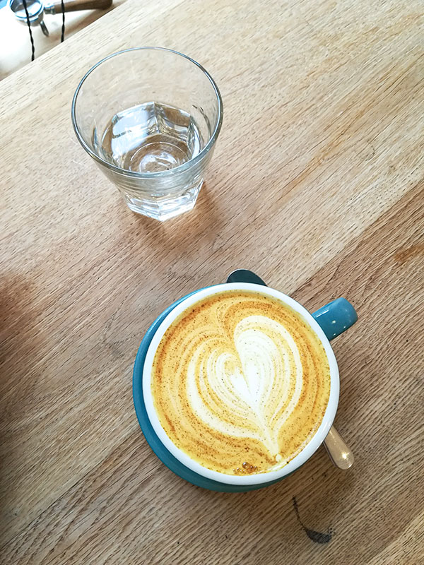 A turmeric latte in a blue cup.